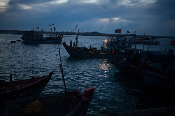 Fishing vessels return from sea at dawn. 